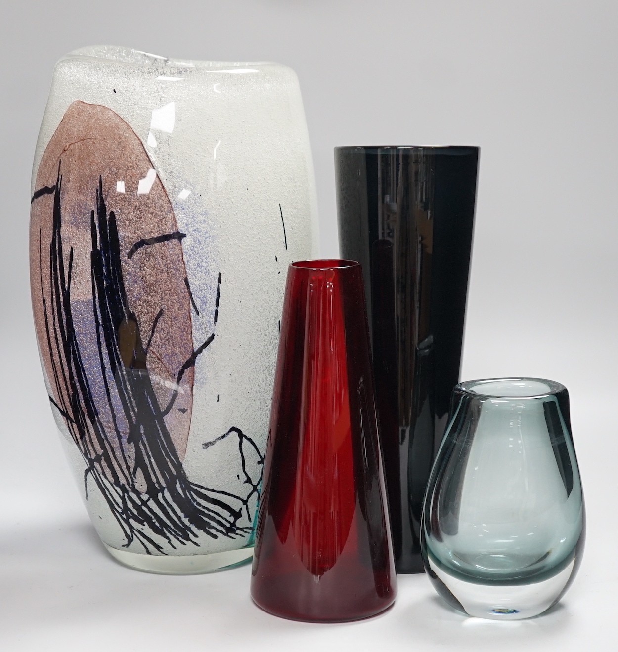 Four studio glass vases, to include Kaj Franck (1911-1989), for Nuutajärvi Notsj, a mid century blue conical glass vase an interesting multi coloured abstract bubble suffused vase- 36cms high